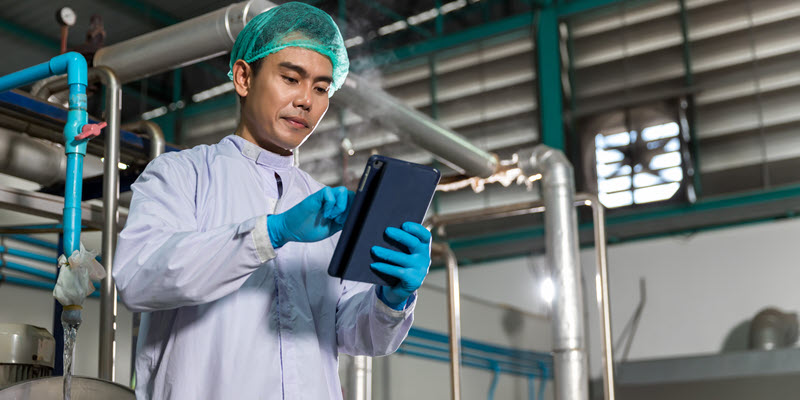 a lab worker checks the tablet